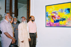 Artist Damodaran, Artist M.V.Devan in front of Damodaran Painting